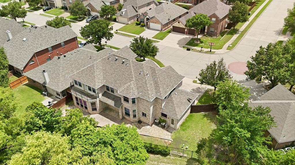 201 Fountainview Drive, Euless, TX 76039 Back aerial view of this expansive residential home featuring a stone and brick exterior with two balconies.