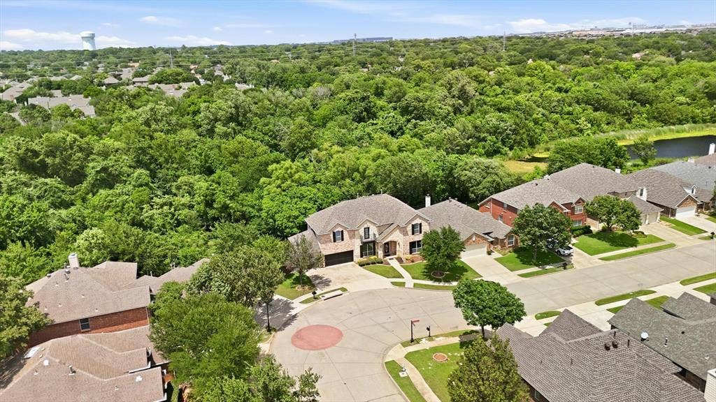 201 Fountainview Drive, Euless, TX 76039 Aerial view of home with nature preserve and lake with jogging trails and fishing pier to the right.