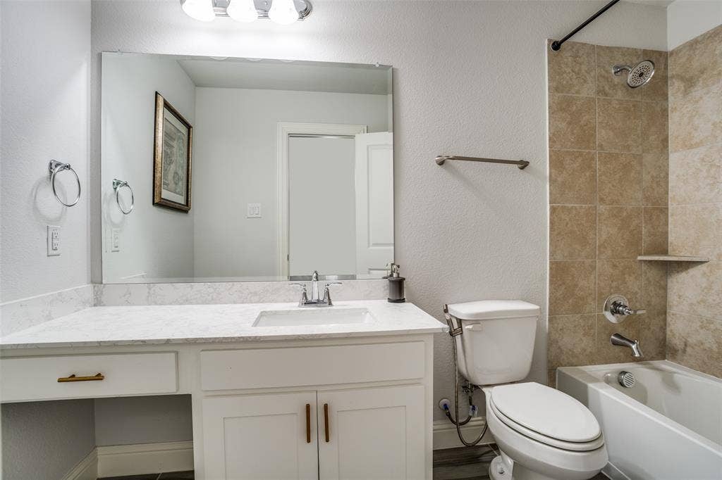 2811 Killdeer Trail, Prosper, TX 75078 Bathroom with shower / bathtub combination, vanity, and a textured wall
