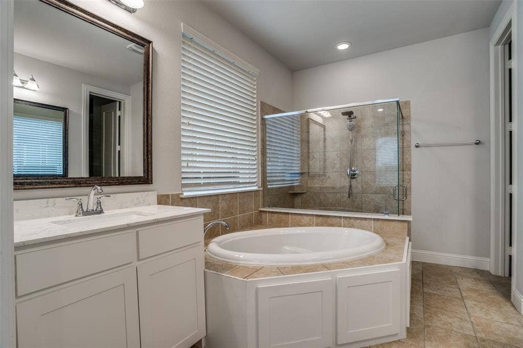 2811 Killdeer Trail, Prosper, TX 75078 Full bathroom featuring a bath, a stall shower, vanity, and light tile patterned floors