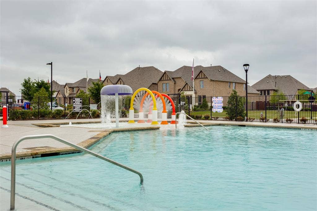2811 Killdeer Trail, Prosper, TX 75078 Community pool featuring a residential view and a water play area