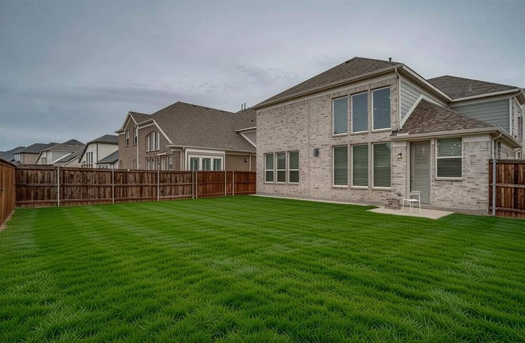2811 Killdeer Trail, Prosper, TX 75078 Expansive rear lawn featuring a wooden privacy fence