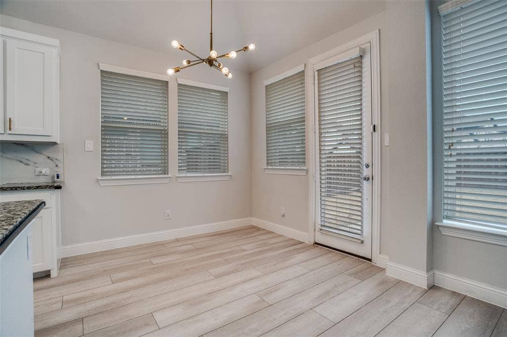 2811 Killdeer Trail, Prosper, TX 75078 Unfurnished dining area featuring a chandelier and light wood-style floors