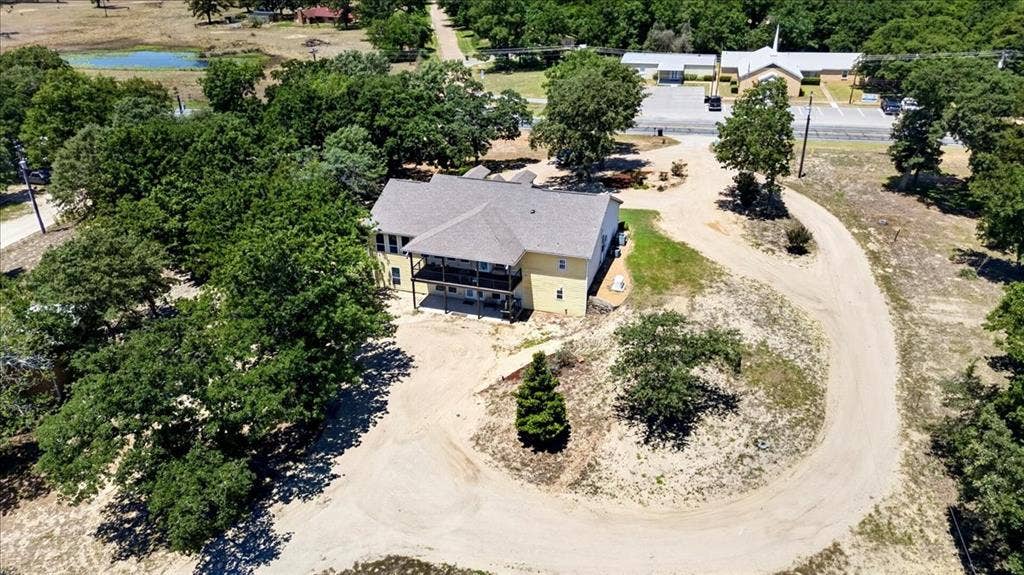11591 Fm 59, Athens, TX 75751 Tan multi-level residence featuring an upper-level balcony and lower-level patio on 9.2 acres at 11591 FM 59 Athens TX 75751 in Crossroads ISD located in Henderson county of Texas.
