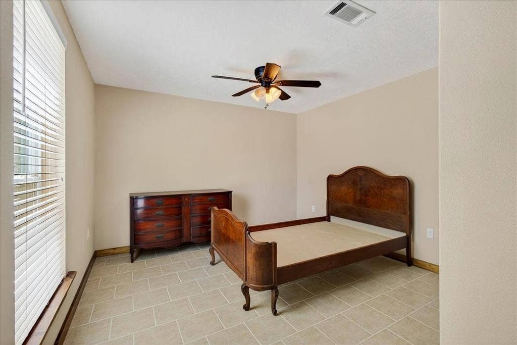 11591 Fm 59, Athens, TX 75751 6th Bedroom Basement level featuring neutral-toned walls, tile flooring, a window with horizontal blinds, and a ceiling fan with integrated lighting, and window.