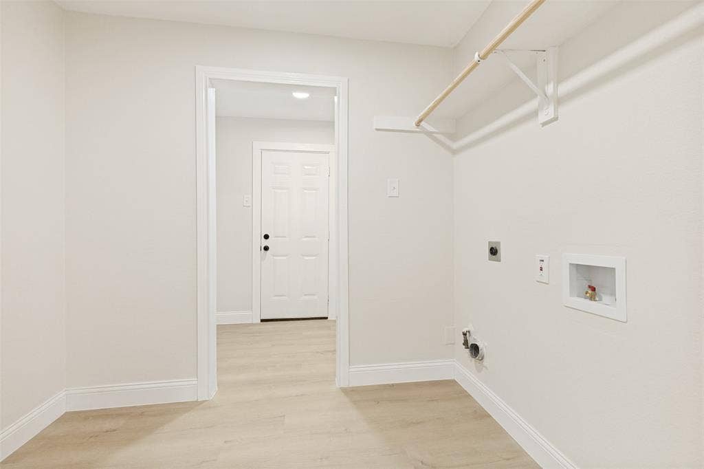 713 Bridgewater Lane, Mesquite, TX 75181 Dedicated laundry area featuring a light wood-finish flooring and a neutral color palette