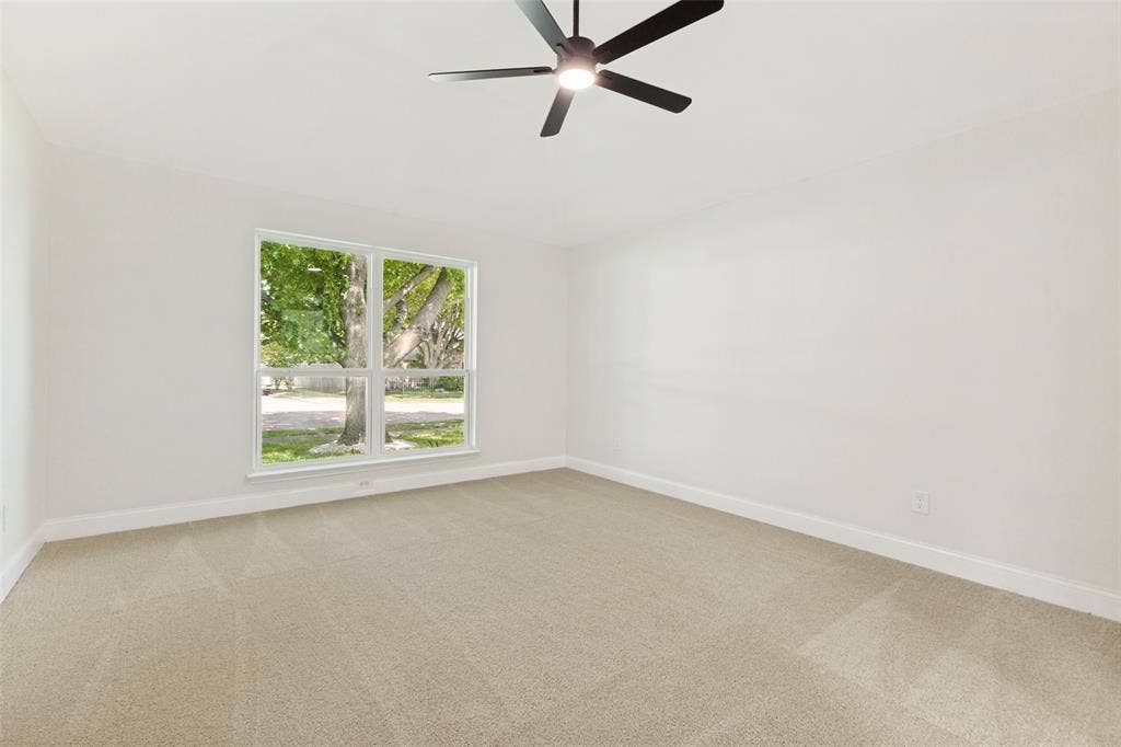 713 Bridgewater Lane, Mesquite, TX 75181 Neutral paint palette with carpet flooring, a large window, a ceiling fan, and white baseboards