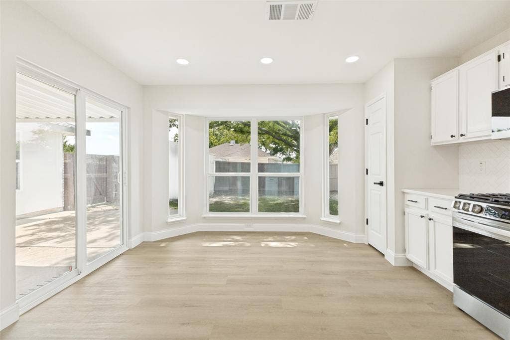713 Bridgewater Lane, Mesquite, TX 75181 Bright interior space with light wood-finish flooring, recessed lighting, and a bay window