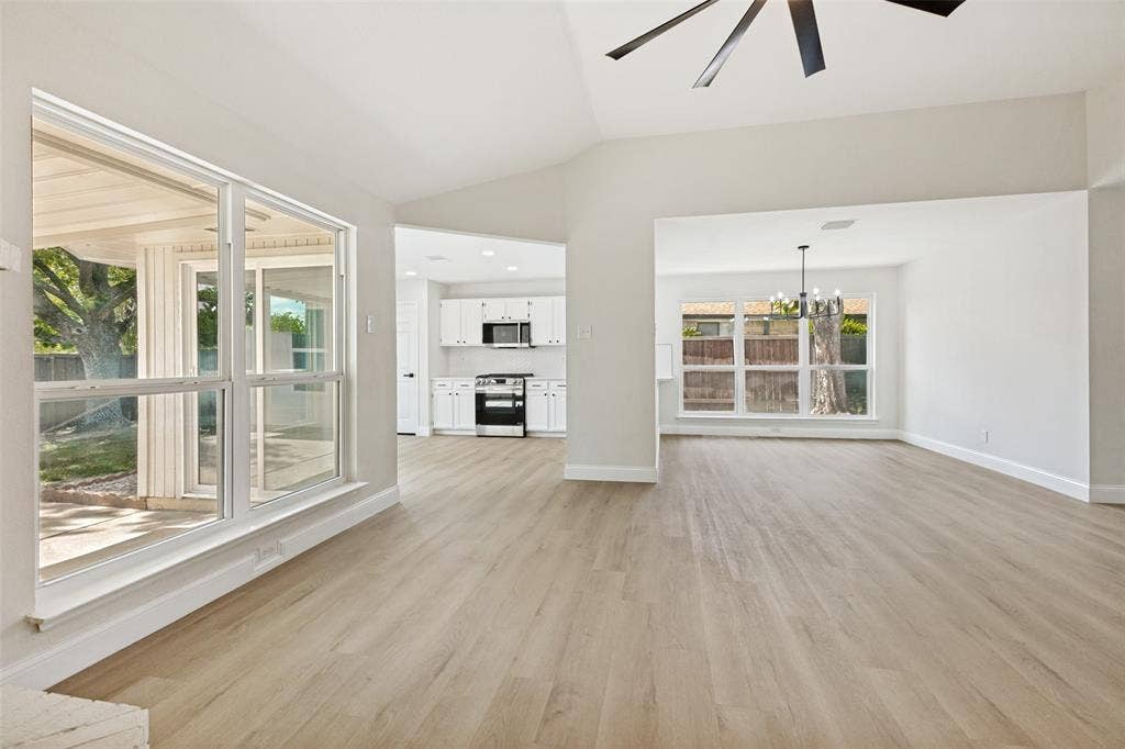 713 Bridgewater Lane, Mesquite, TX 75181 Vaulted ceiling living space featuring wood-finish flooring and a contemporary ceiling fan