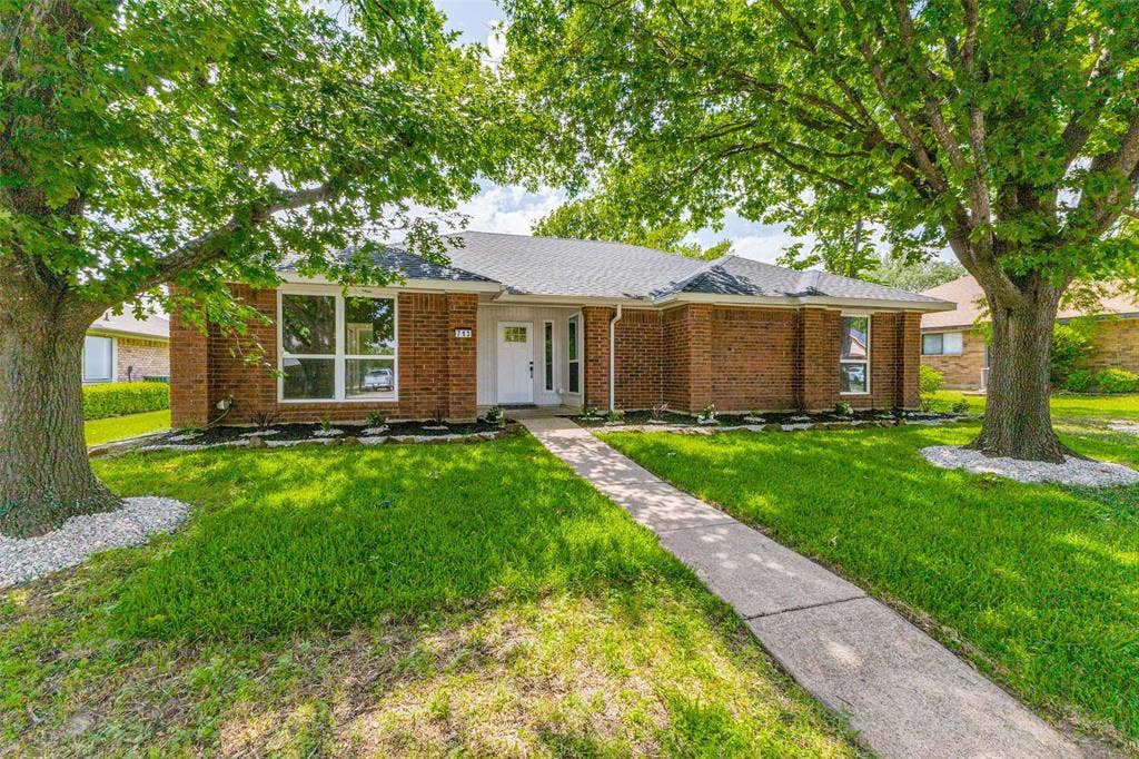 713 Bridgewater Lane, Mesquite, TX 75181 Traditional brick exterior with a white front door and surrounding sidelights