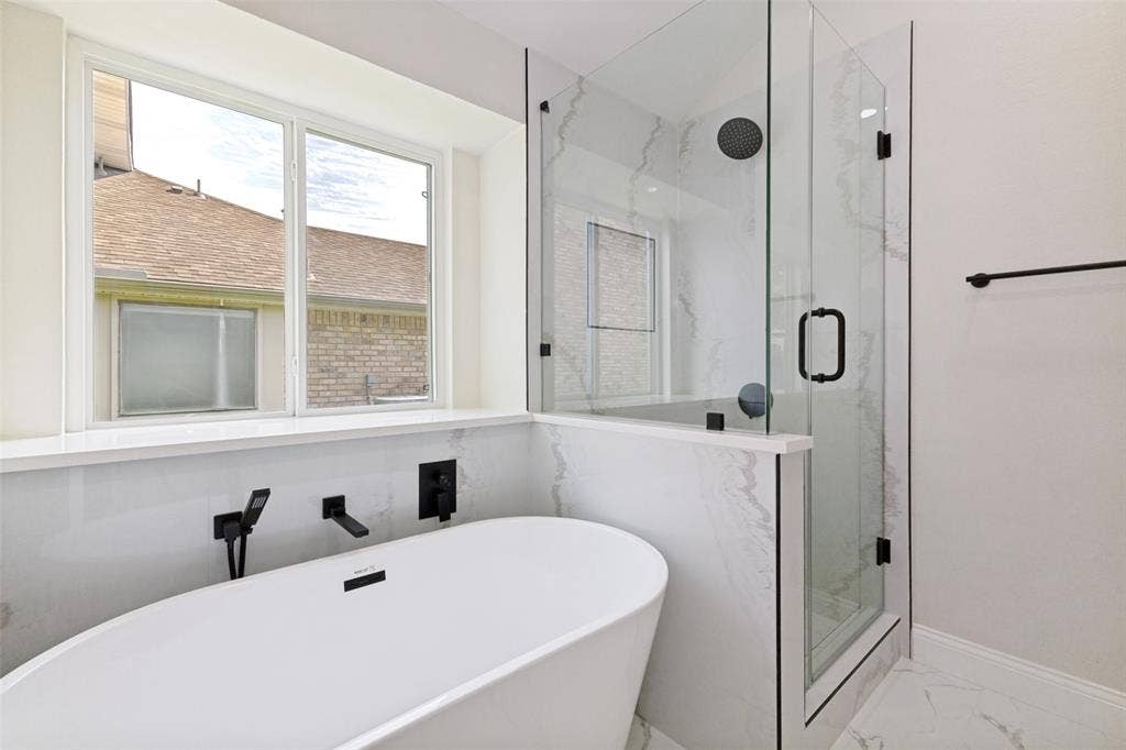 713 Bridgewater Lane, Mesquite, TX 75181 Freestanding soaking tub with wall-mounted matte black fixtures