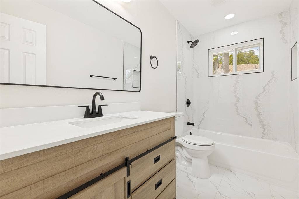 713 Bridgewater Lane, Mesquite, TX 75181 Bathroom featuring a wood-finish vanity with black hardware, white countertop, and a rectangular undermount sink
