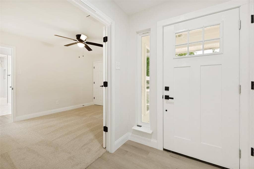 713 Bridgewater Lane, Mesquite, TX 75181 Entryway featuring a white craftsman-style door with a multi-pane window and matte black hardware