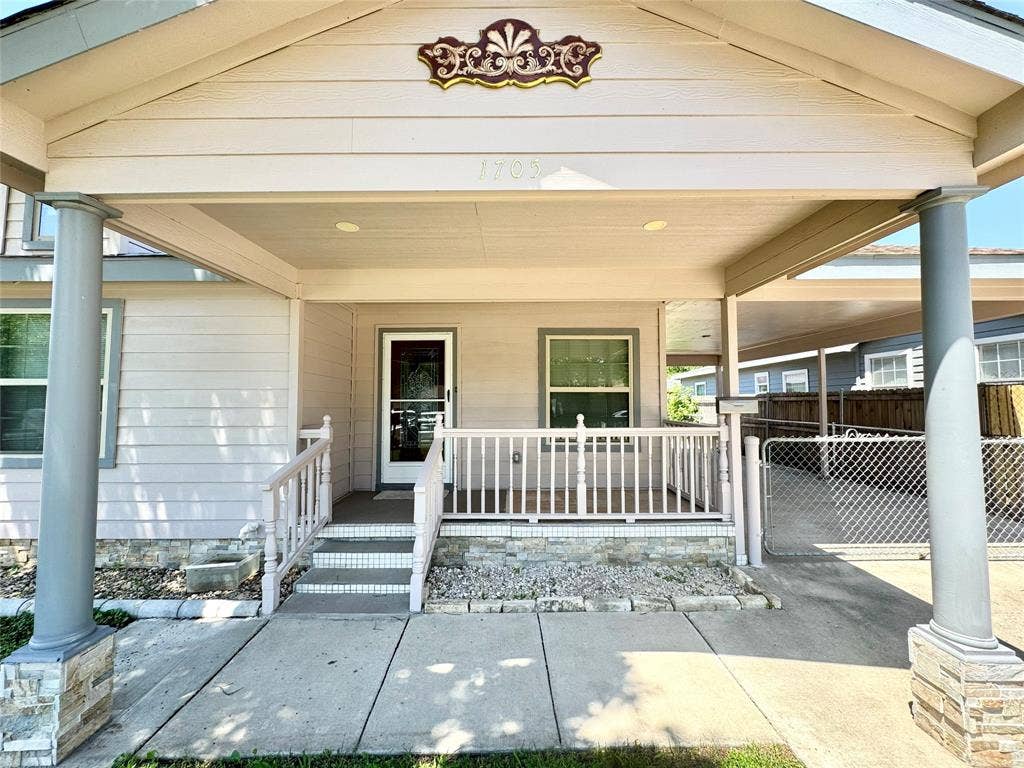 Covered front porch with stone-clad pillars and base