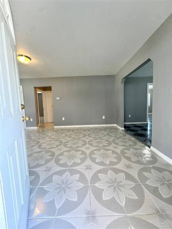 Foyer featuring patterned tile flooring, neutral wall paint, and a semi-flush ceiling light fixture