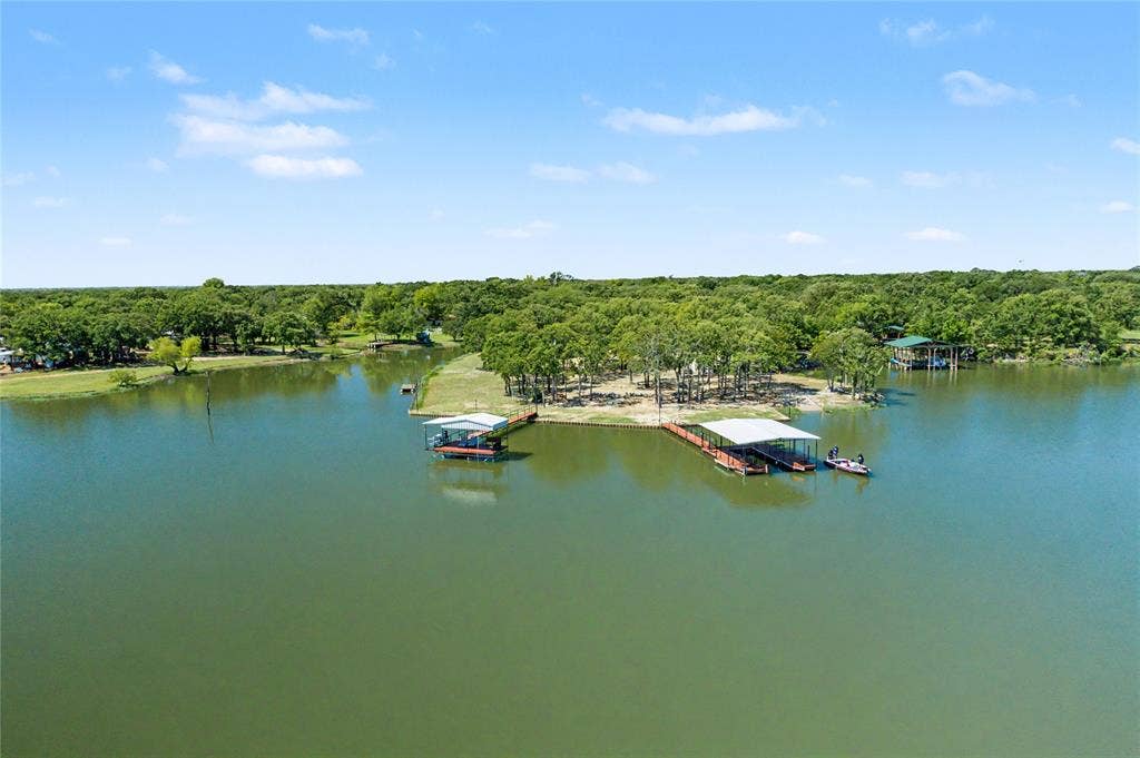 101 Friendship Circle, West Tawakoni, TX 75474 Expansive lakefront property featuring multiple boat docks with covered slips