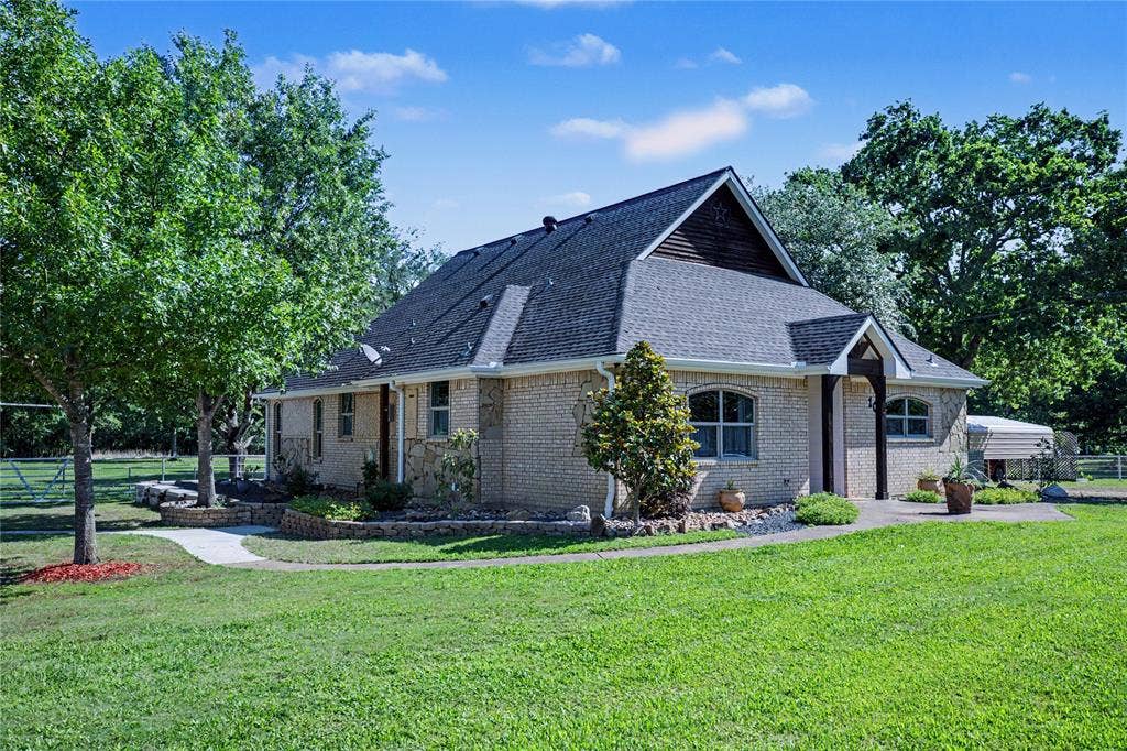 101 Friendship Circle, West Tawakoni, TX 75474 Brick exterior with gabled roofline and dark shingle roofing