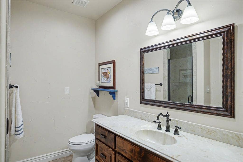 101 Friendship Circle, West Tawakoni, TX 75474 Bathroom vanity with a light-toned countertop, integrated oval sink, and dark bronze-finish fixtures