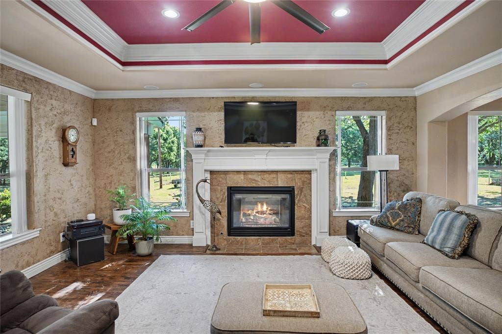 101 Friendship Circle, West Tawakoni, TX 75474 Living space featuring a central fireplace with stone tile surround and a substantial white mantelpiece