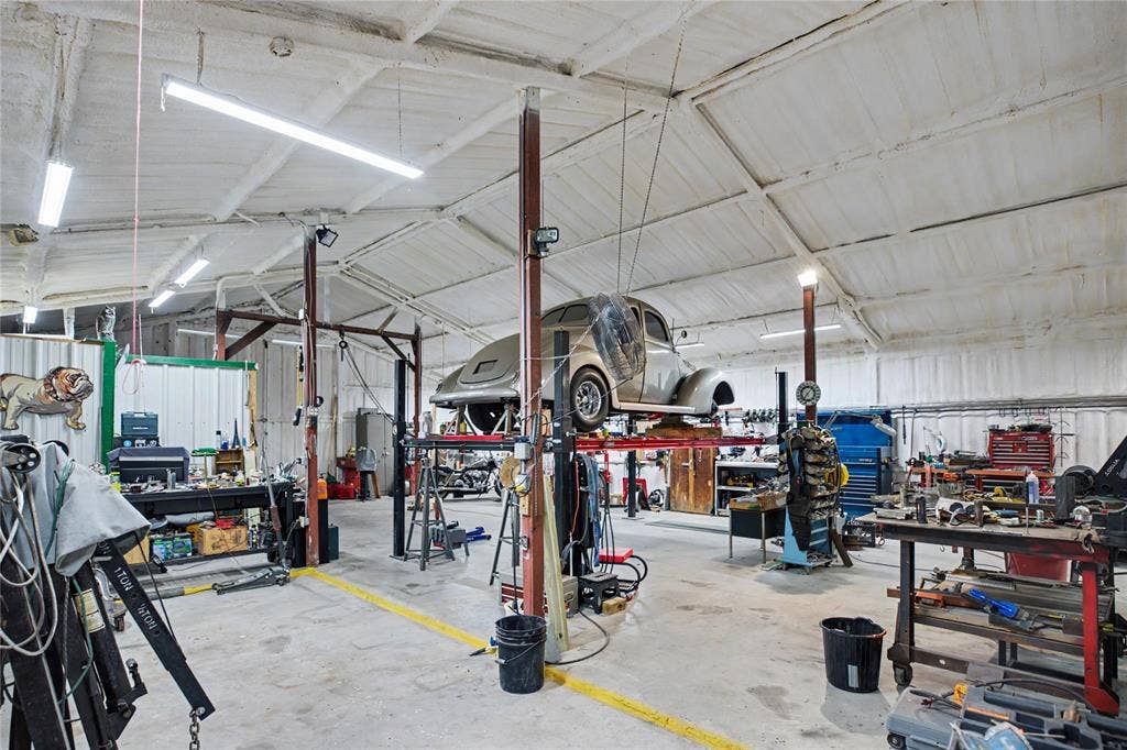 101 Friendship Circle, West Tawakoni, TX 75474 Spacious industrial interior featuring a high vaulted ceiling, exposed structural beams, and concrete flooring