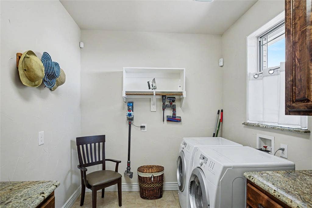101 Friendship Circle, West Tawakoni, TX 75474 Laundry area featuring light-toned walls, a window with a stone-finish sill, and built-in white shelving