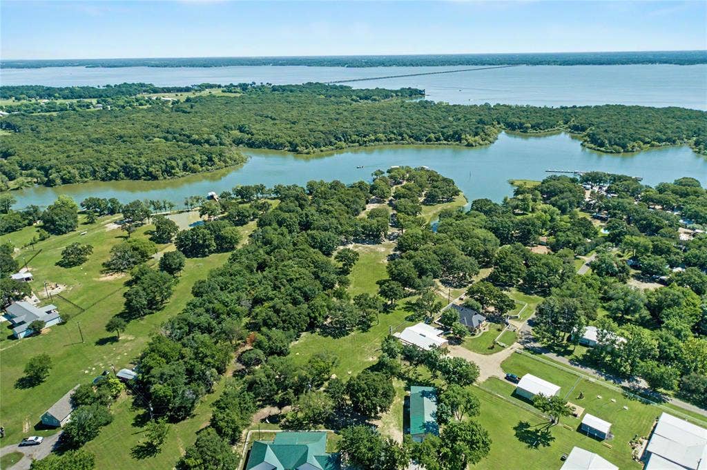 101 Friendship Circle, West Tawakoni, TX 75474 Expansive aerial showcasing a body of water, lush green trees, and scattered residential properties