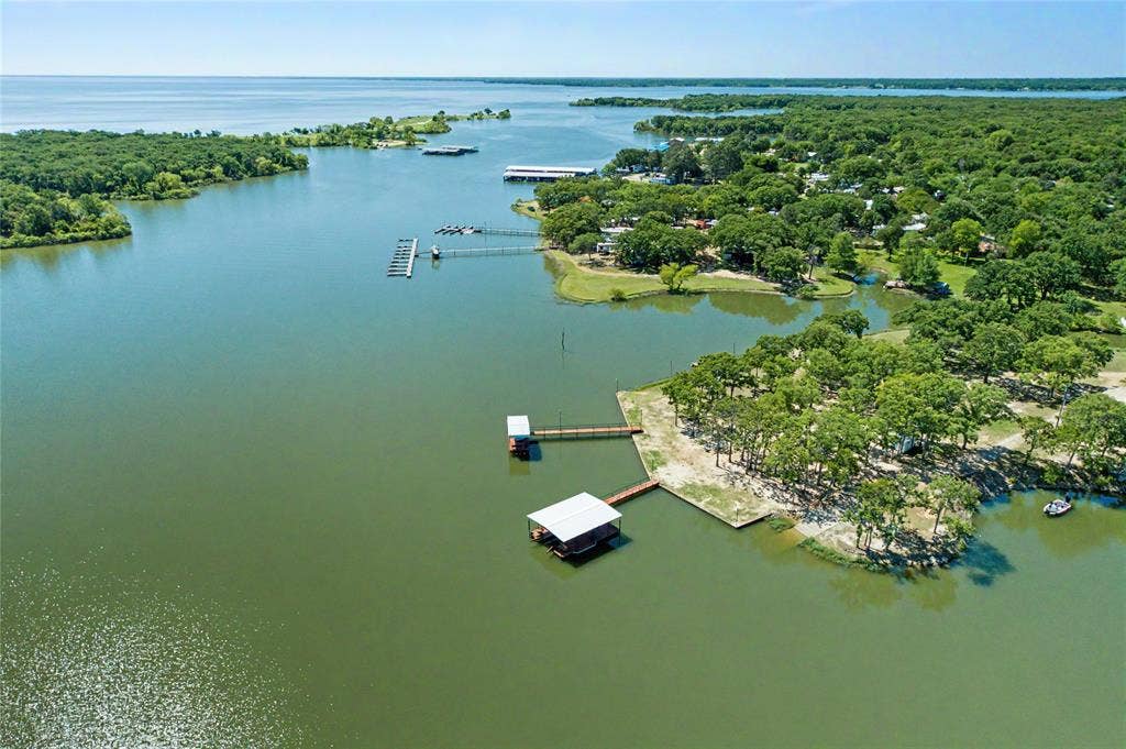 101 Friendship Circle, West Tawakoni, TX 75474 Waterfront property featuring multiple boat docks, mature trees, and direct water access