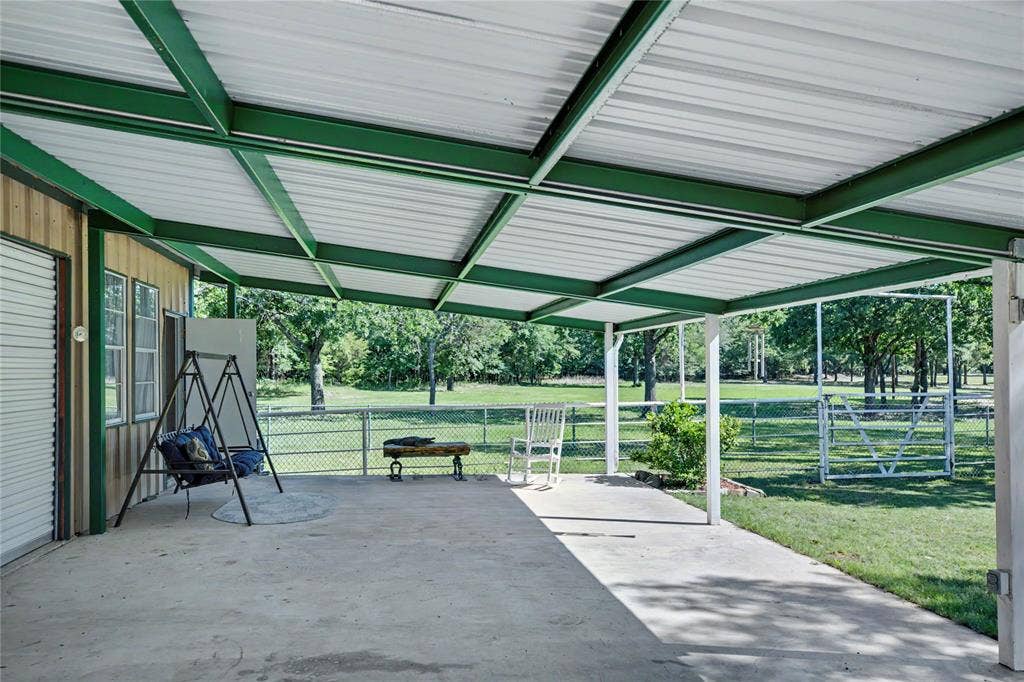 101 Friendship Circle, West Tawakoni, TX 75474 Expansive covered patio featuring a concrete surface and a green metal roof structure