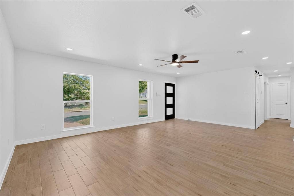 3853 Happy Canyon Drive, Dallas, TX 75241 Spacious interior featuring wood-finish flooring, recessed lighting, and a contemporary ceiling fan