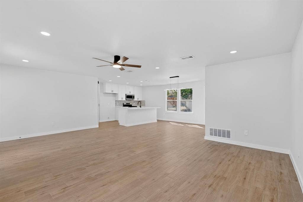 3853 Happy Canyon Drive, Dallas, TX 75241 Expansive open-concept room featuring wood-finish flooring, recessed lighting, and a contemporary ceiling fan