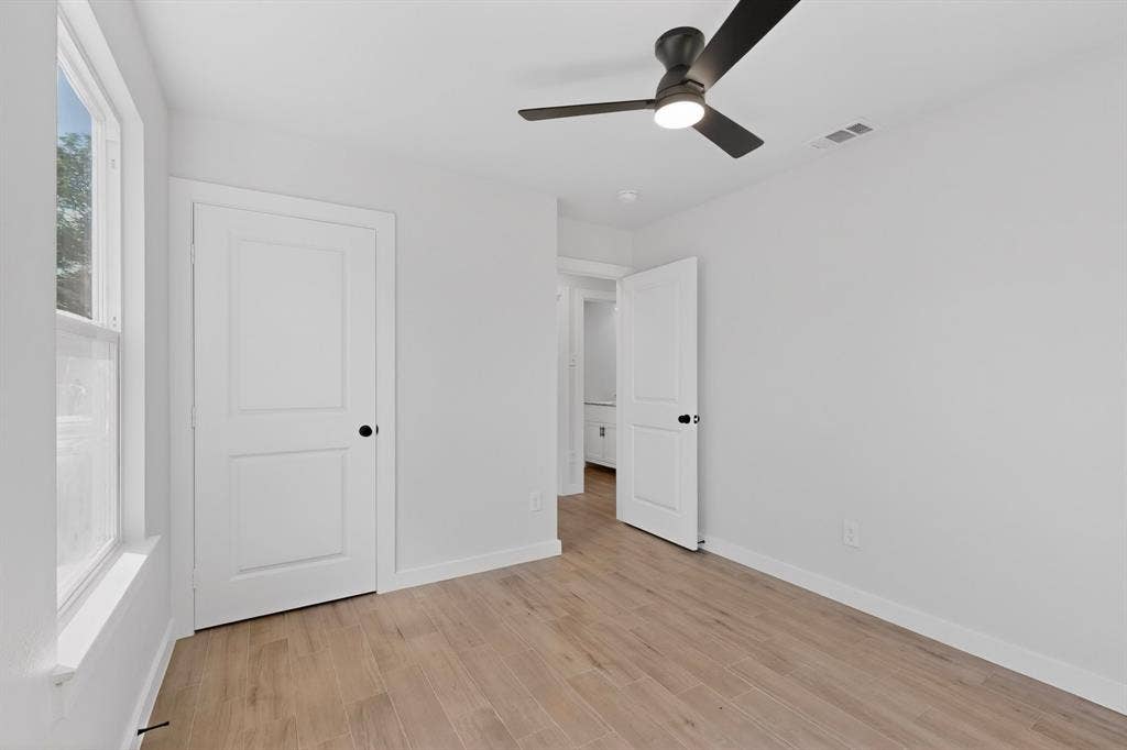 3853 Happy Canyon Drive, Dallas, TX 75241 Bright interior room featuring wood-finish flooring, a contemporary ceiling fan with integrated lighting, and a white two-panel door