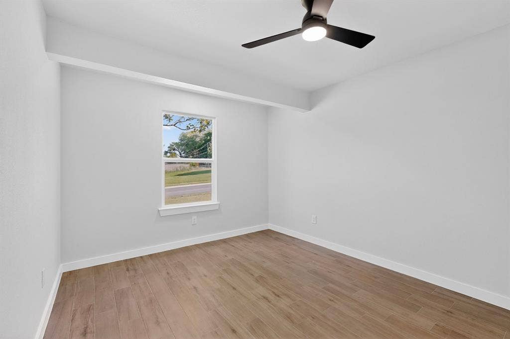 3853 Happy Canyon Drive, Dallas, TX 75241 Bright interior space featuring wood-finish flooring, a contemporary ceiling fan with integrated lighting, and a window with white trim