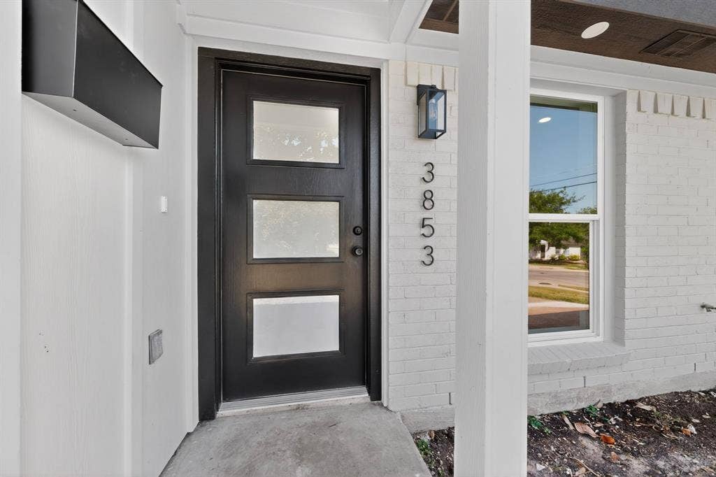 3853 Happy Canyon Drive, Dallas, TX 75241 Black modern entry door with three frosted glass panels