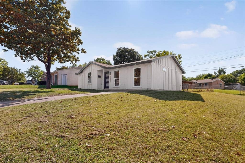 3853 Happy Canyon Drive, Dallas, TX 75241 Contemporary-style home featuring white board and batten siding, a dark gray roof, and prominent windows