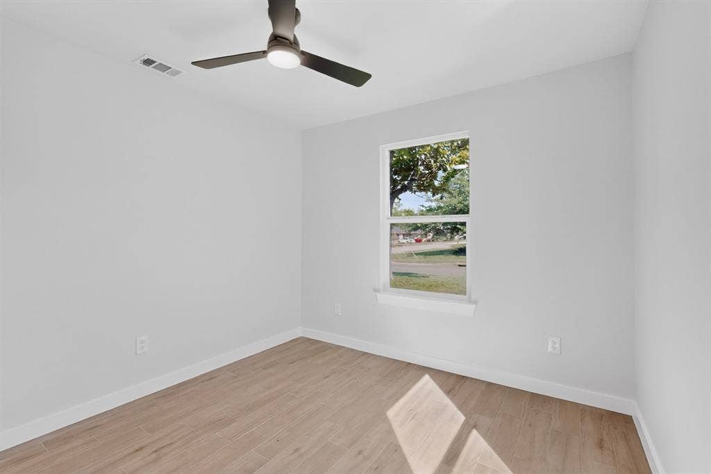 3853 Happy Canyon Drive, Dallas, TX 75241 Light-filled room featuring wood-finish flooring and a contemporary ceiling fan