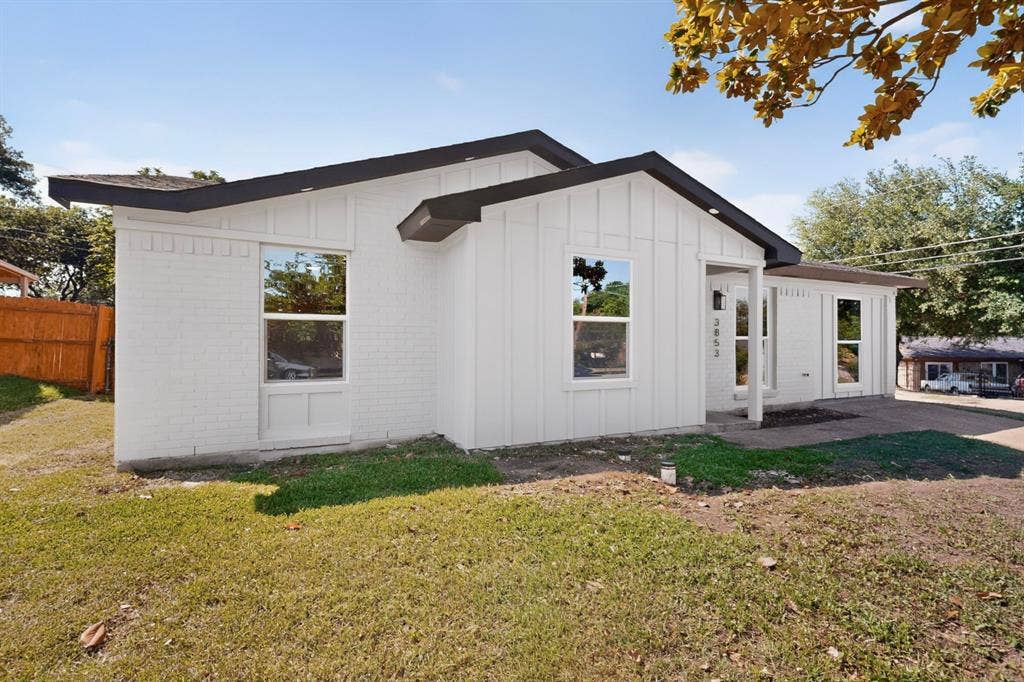 3853 Happy Canyon Drive, Dallas, TX 75241 Crisp white exterior featuring board and batten siding and painted brick