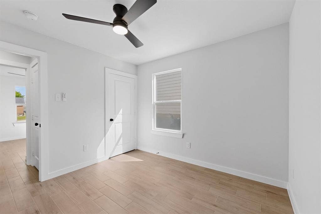3853 Happy Canyon Drive, Dallas, TX 75241 Bright interior space featuring a ceiling fan with integrated lighting, wood-finish flooring, and white baseboards