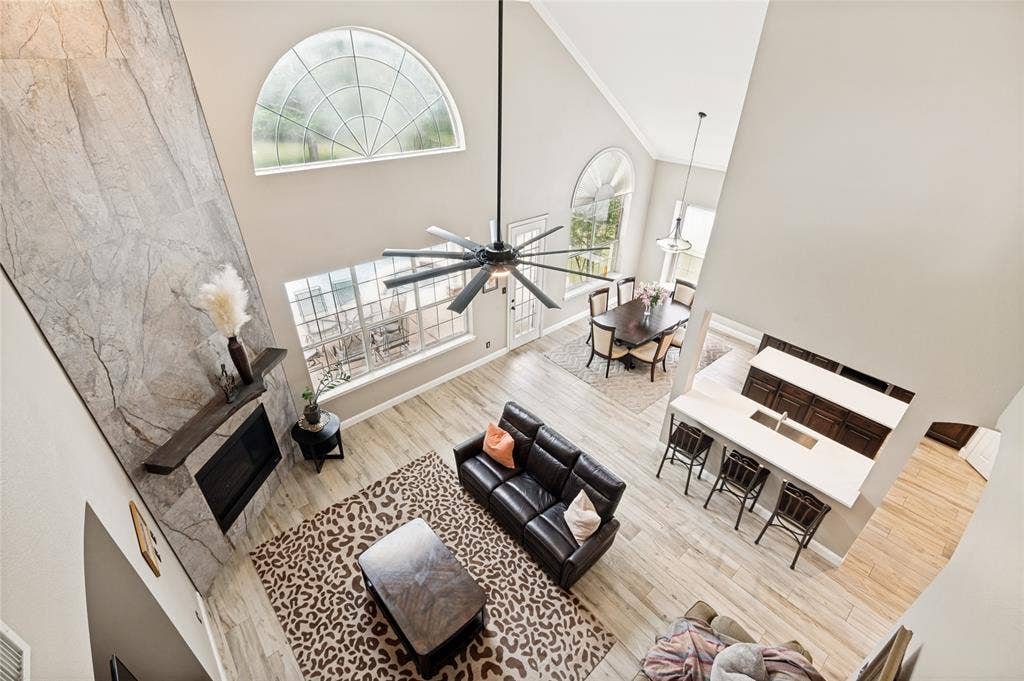 108 Appalachian Way, McKinney, TX 75071 Soaring vaulted ceilings above a living area featuring a floor-to-ceiling stone-finish fireplace