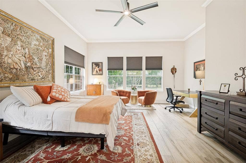 108 Appalachian Way, McKinney, TX 75071 Spacious room featuring light wood-finish flooring, high ceilings with crown molding, and a modern ceiling fan