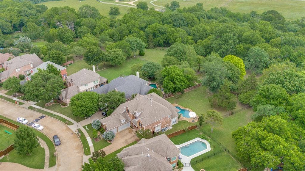 108 Appalachian Way, McKinney, TX 75071 Aerial perspective showcasing multiple properties, each featuring a private swimming pool, mature landscaping, and fenced backyards