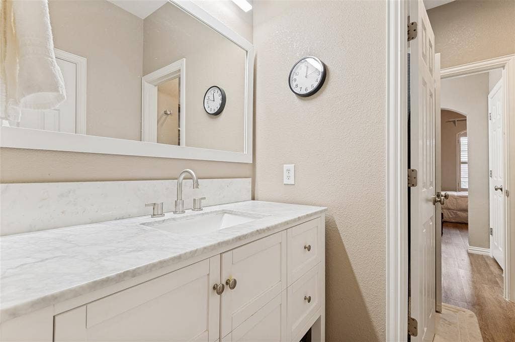 108 Appalachian Way, McKinney, TX 75071 Bathroom vanity featuring a white countertop with integrated sink and brushed nickel faucet