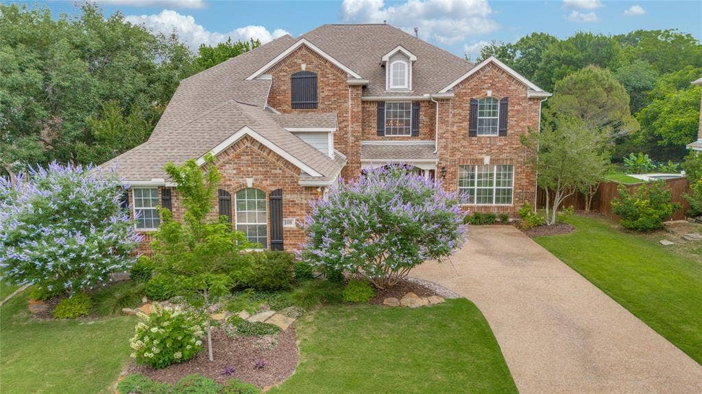 108 Appalachian Way, McKinney, TX 75071 Brick two-story residence featuring multiple gables and a multi-level roofline