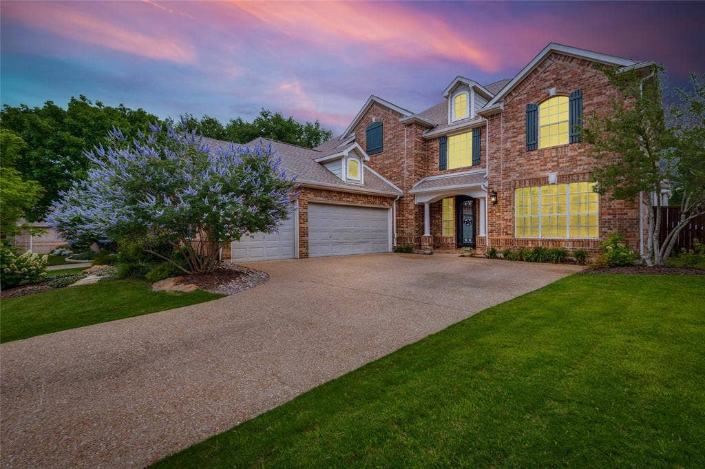 108 Appalachian Way, McKinney, TX 75071 Brick exterior with multiple dormer windows, a three-car garage, and an exposed aggregate driveway