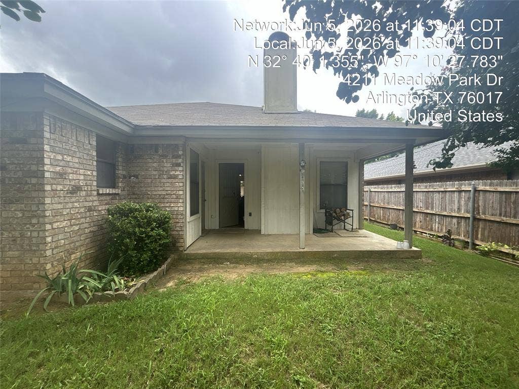 4211 Meadow Park Drive, Arlington, TX 76017 Rear patio featuring a covered concrete slab, brick exterior, and partial fencing