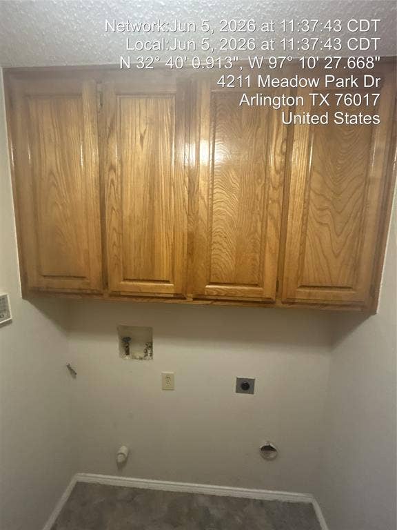 4211 Meadow Park Drive, Arlington, TX 76017 Utility space featuring light wood cabinetry, a neutral wall finish, and a gray floor