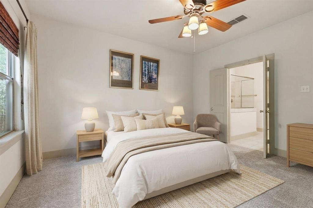 413 Collins Street, Argyle, TX 76226 Serene primary bedroom showcasing neutral tones, dual nightstands with integrated lighting, a ceiling fan with fixture, and direct access to an ensuite bathroom