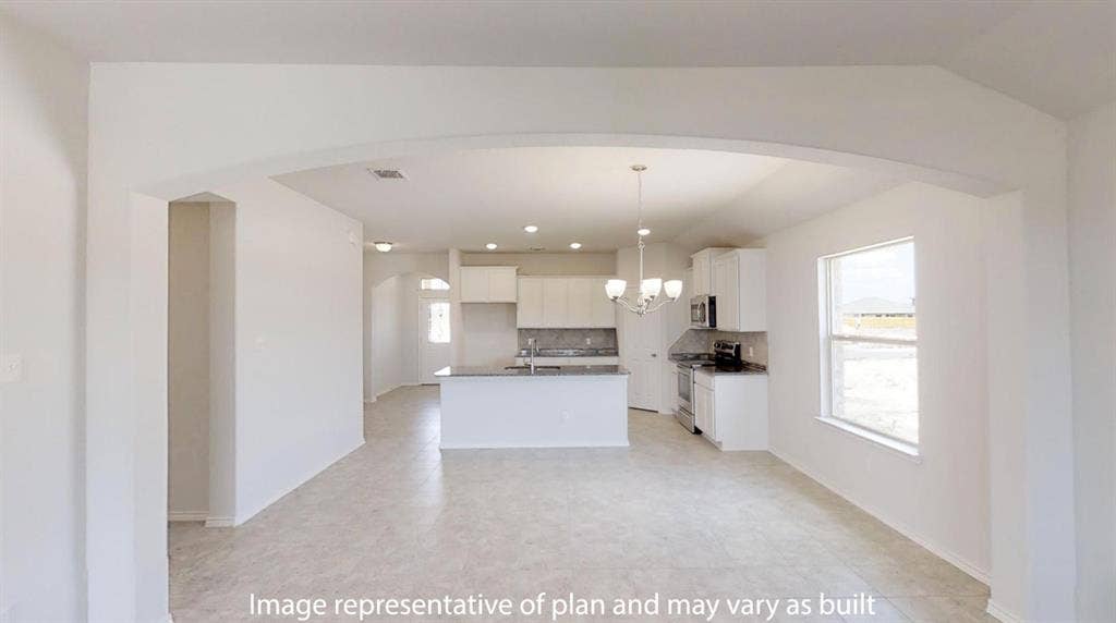 Open concept living space featuring a broad archway