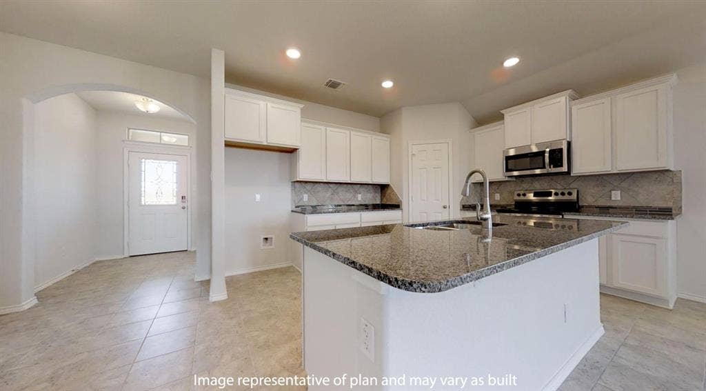 Contemporary kitchen featuring white cabinetry, stainless steel appliances, a large island with an undermount sink, granite countertops, and a tiled backsplash