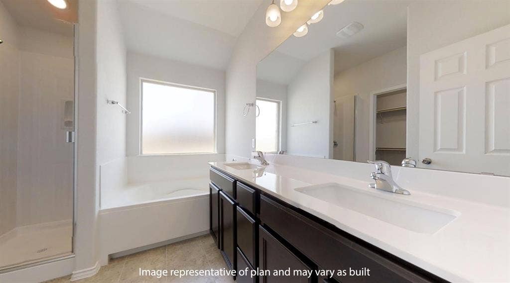 Bathroom featuring a dual vanity with dark wood-finish cabinetry and white countertops