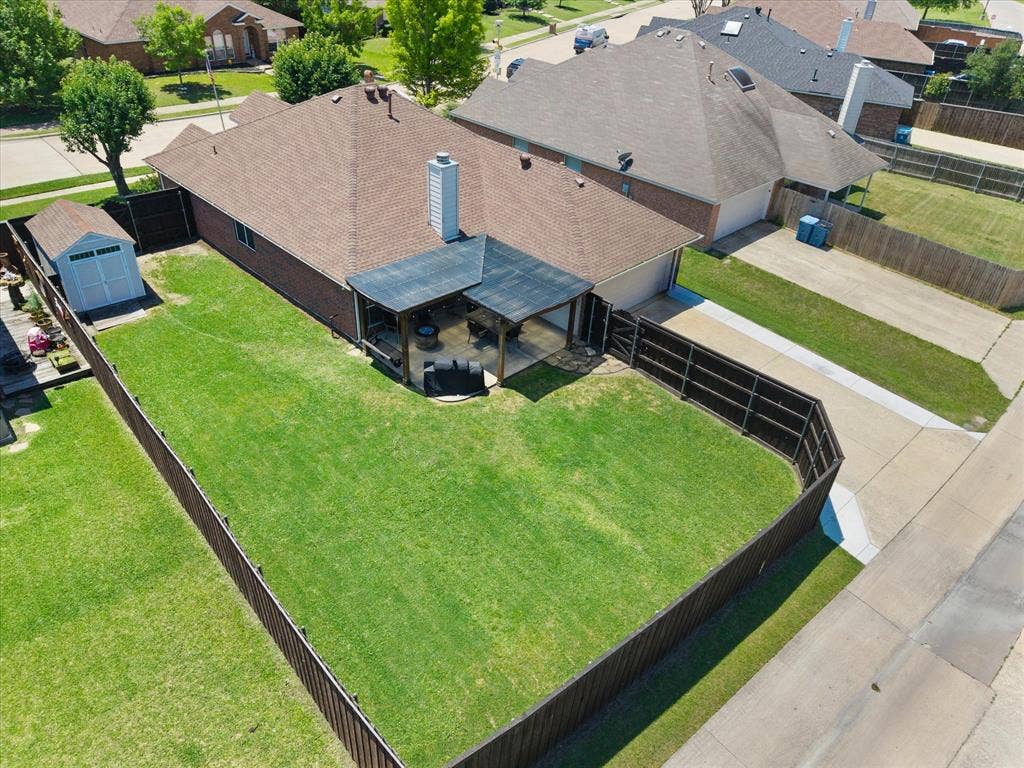 Aerial view of the backyard and driveway.